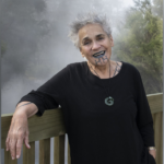 Banner image: Ngāhuia standing with arm draped over fence