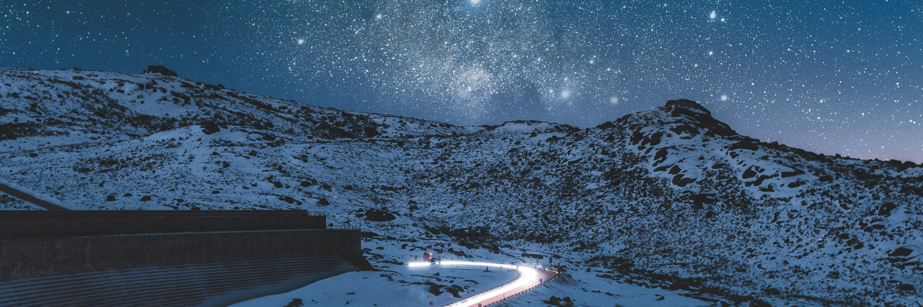 Illuminated road with night sky above